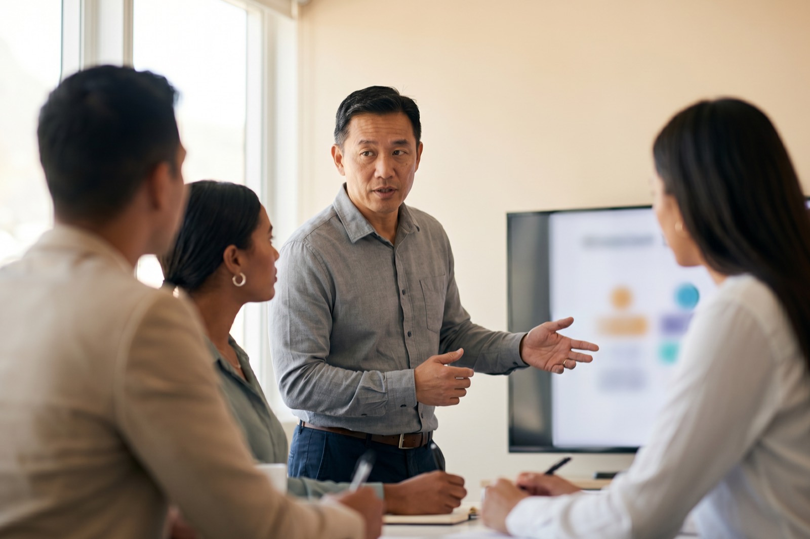 A multidisciplinary team of professionals collaborating in a creative office